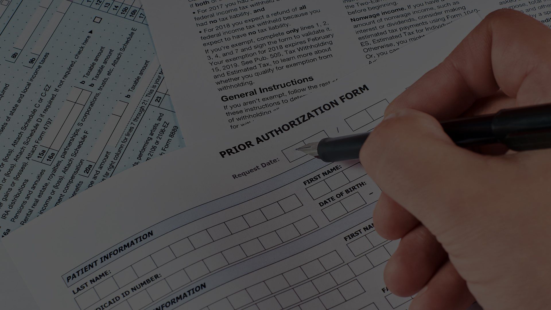 Close up image of a person writing on a form titled "Prior Authorization Form"