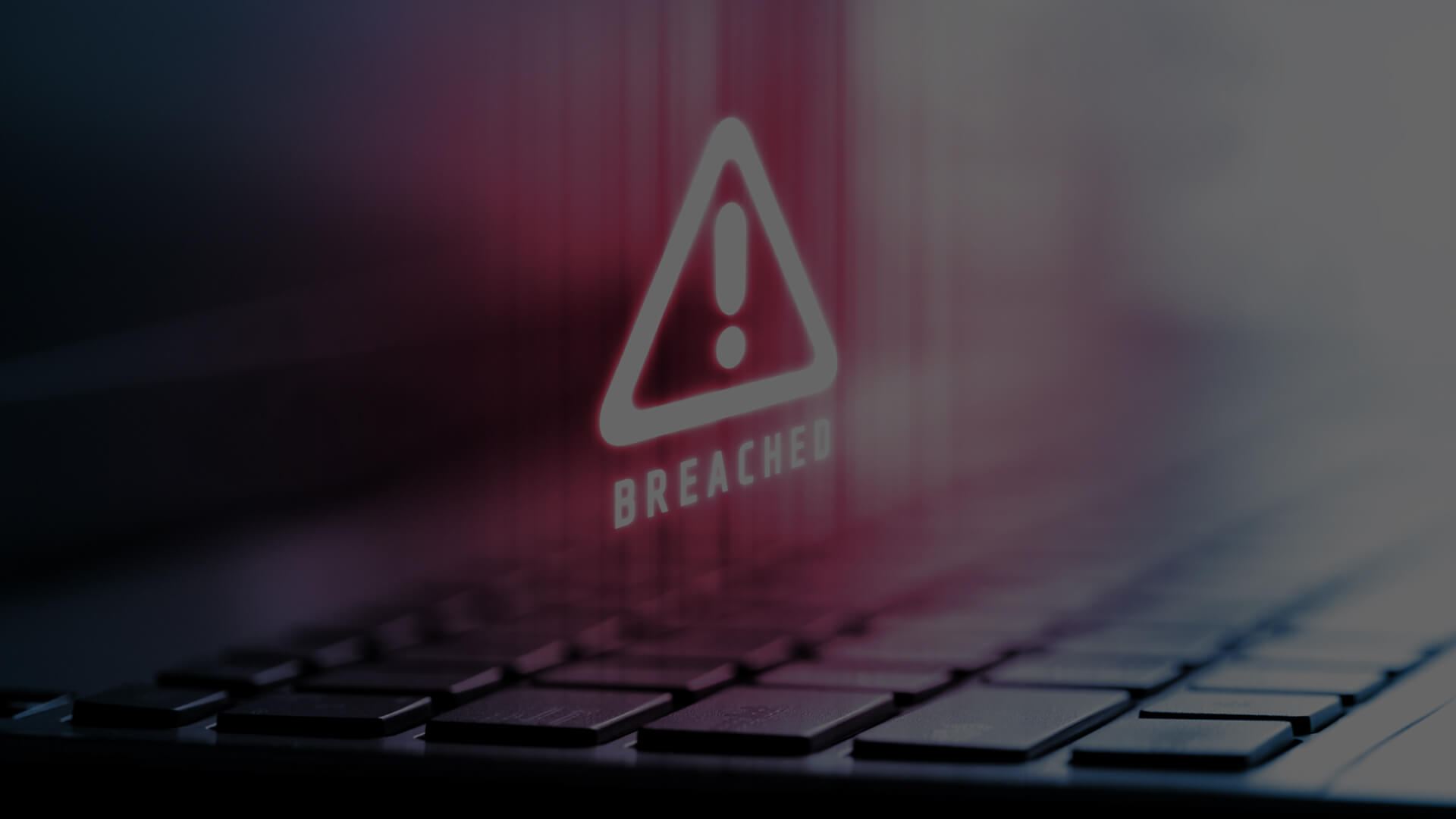 Cybersecurity breach alert displayed over a dark laptop keyboard, highlighting the urgent need for AI-driven security measures in information technology.