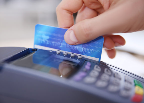 Payment processing | Person swiping their credit card through a card reader