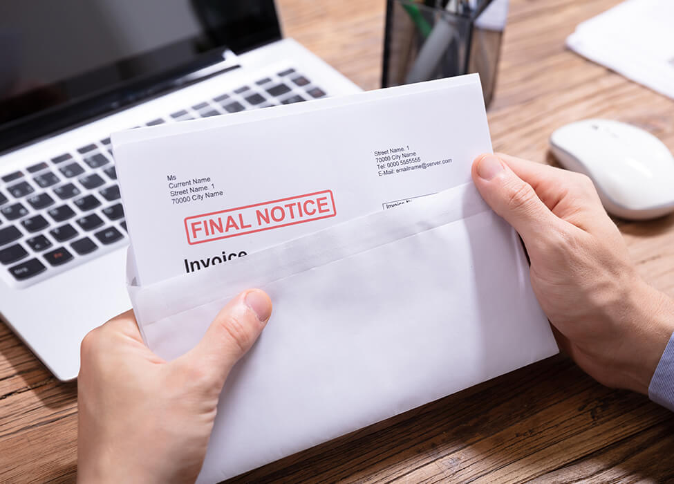 Person opening a letter that says "Final Notice" in large red print