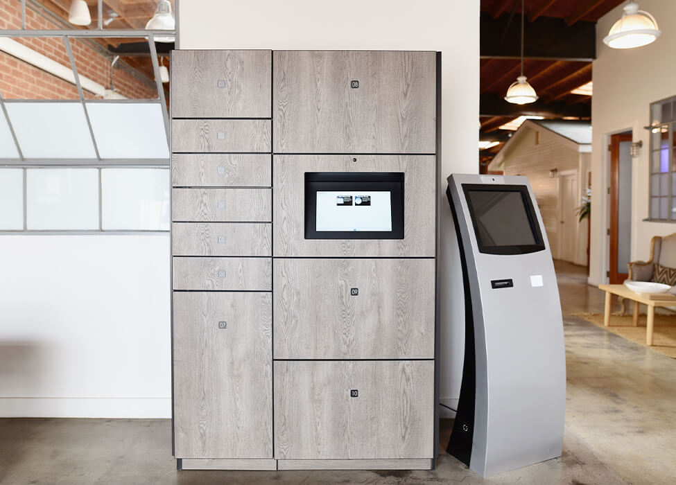 Smart lockers for offices in a modern workspace with a centralized digital control panel, set against a background of a loft-style office with natural lighting